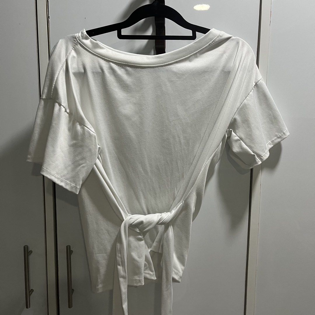 White Tie-Back T-Shirt Off-Shoulder Top (Category: Shirts) located in Manila. Submitted by 4ngeluh (Listing ID 1462682643, Image 2). Description: - Soft and flowy white t-shirt - Unique tie-back detail - Can be worn off-shoulder for a casual vibe - Short sleeves - Versatile for everyday wear or layering - Easily pairs with jeans or skirts.