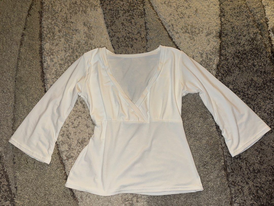White V-neck Bell Sleeve Top (Category: Blouses) located in Cebu City. Submitted by cholinesterase (Listing ID 1462862878, Image 1). Description: - Classic white V-neck top - Soft and stretchy fabric for comfort - Flattering fitted waist - Stylish elbow-length bell sleeves - Versatile for casual or dressed-up looks.