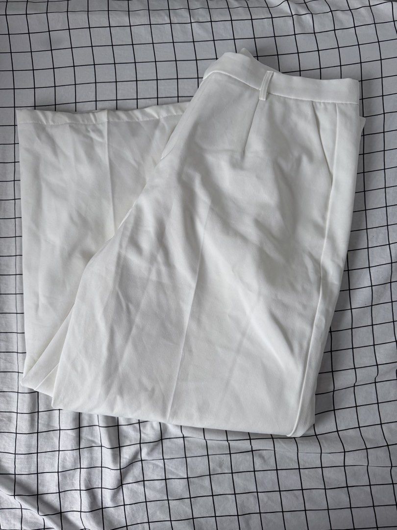 White Wide Leg Trousers (Category: Other Bottoms) located in Quezon City. Submitted by sellantroe (Listing ID 1462777160, Image 1). Description: - Plus size - White wide-leg trousers - High-waisted with belt loops - Two front pockets - Simple and classic design - Versatile for dressing up or down.