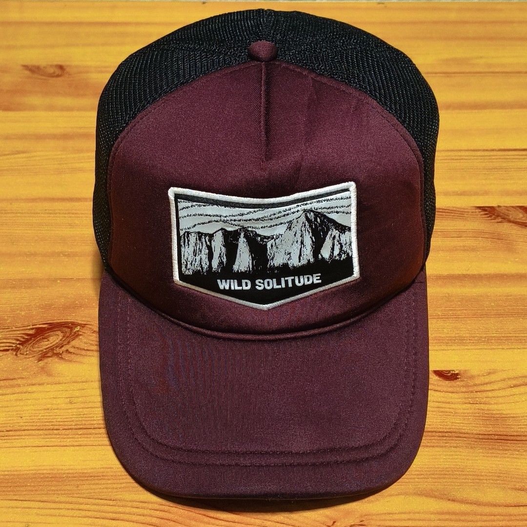 Wild Solitude Trucker Cap Burgundy Black Mesh (Category: Caps & Hats) located in Manila. Submitted by caps08 (Listing ID 1462875411, Image 2). Description: - Burgundy and black trucker cap - Features 'Wild Solitude' patch with mountain graphic - Breathable mesh back - Adjustable snapback closure - Ideal for outdoor adventures and everyday wear.