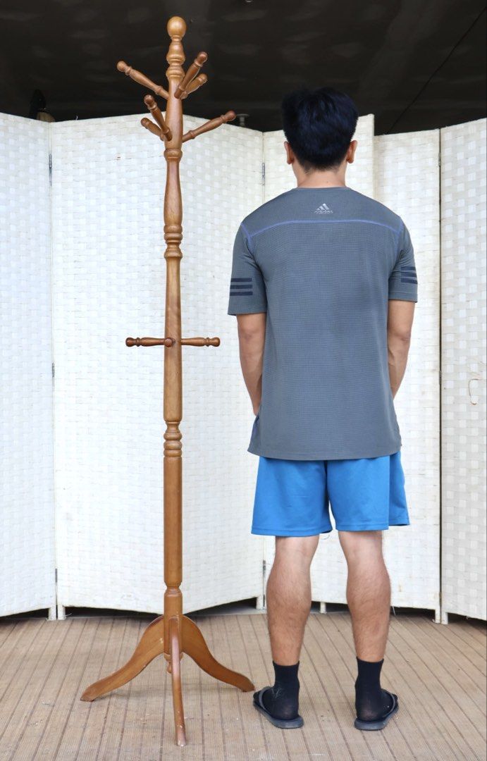Wooden Coat Rack Stand with Multiple Hooks (Category: Shelves, Cabinets & Racks) located in Bulacan. Submitted by FurnitureGallery (Listing ID 1462833864, Image 2). Description: - Solid wood construction for durability. - Tiered design with multiple hooks for ample storage. - Stable three-leg base for secure placement. - Warm, natural wood finish complements any decor. - Ideal for organizing coats, hats, and scarves in entryways or bedrooms. - Si