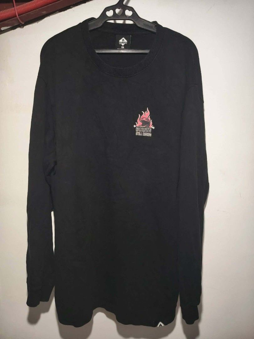 Y2K Burnin Boyz Still Racing Flame Sweater Jacket (Category: Coats, Jackets and Outerwear) located in Rizal, Mindoro Occidental. Submitted by thrift.finds_5103 (Listing ID 1462837890, Image 2). Description: The selected region features the back graphic of a BURNIN brand long-sleeve black streetwear shirt. The artwork displays a distinctive 3x3 grid of nine multi-colored motorcycle and skater helmets adorned with classic flame patterns. Alternativ