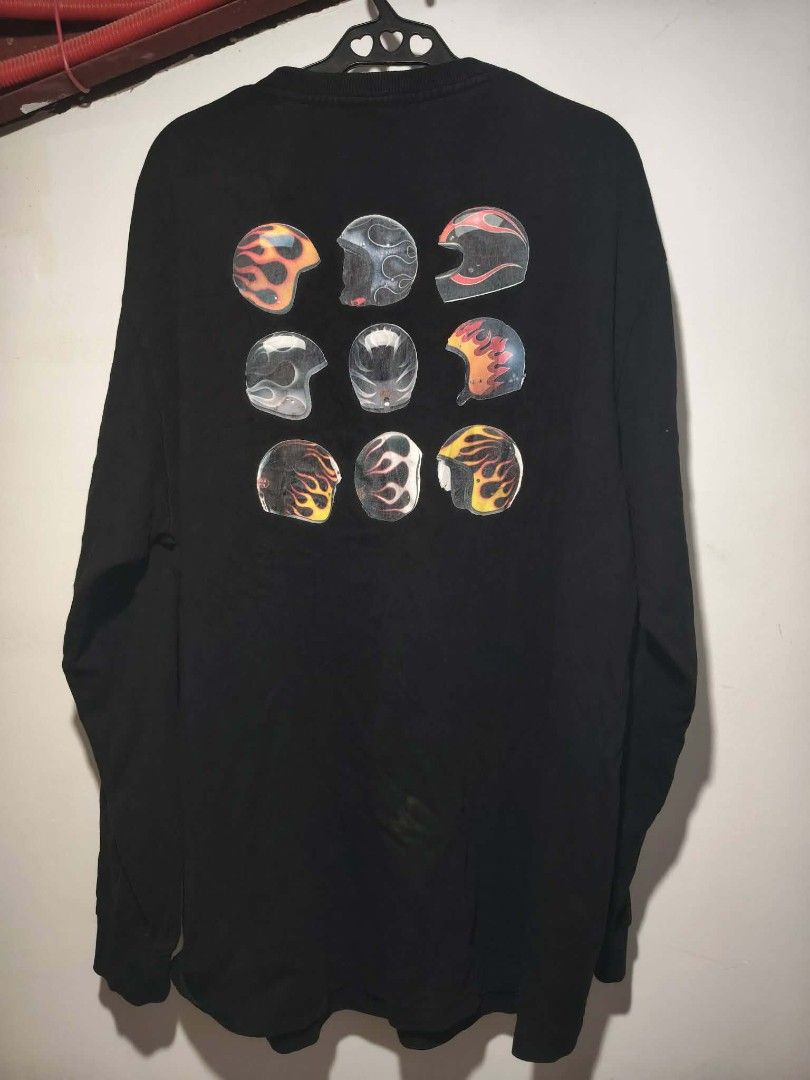 Y2K Burnin Boyz Still Racing Flame Sweater Jacket (Category: Coats, Jackets and Outerwear) located in Rizal, Mindoro Occidental. Submitted by thrift.finds_5103 (Listing ID 1462837890, Image 3). Description: The selected region features the back graphic of a BURNIN brand long-sleeve black streetwear shirt. The artwork displays a distinctive 3x3 grid of nine multi-colored motorcycle and skater helmets adorned with classic flame patterns. Alternativ