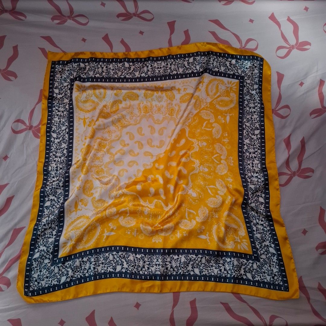 Yellow Paisley Print Silk Scarf (Category: Scarves) located in Dasmarinas. Submitted by luzella (Listing ID 1462756405, Image 1). Description: - Beautiful yellow scarf with a classic paisley print. - Elegant dark blue and white border. - Fabric boasts a lovely sheen. - Highly versatile: wear it around your neck, tie it to your bag, or use it as a hair accessory. - Approximate dimensions: 20x20 inches..