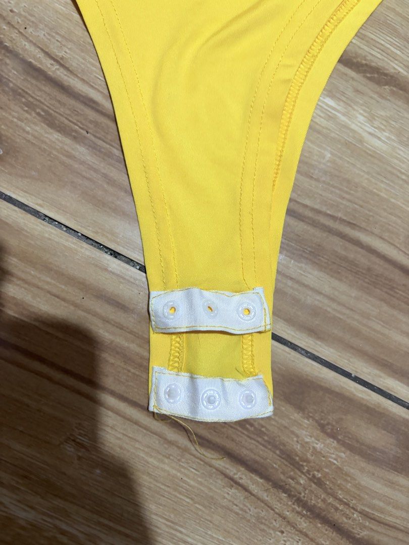 Yellow Sleeveless Bodysuit Snap Crotch (Category: Sleeveless) located in Quezon City. Submitted by kyjnll (Listing ID 1462880800, Image 3). Description: Used once only - Bright yellow sleeveless bodysuit - High neckline with racerback design - Thong bottom with convenient snap closure at crotch - Stretchy material for ultimate comfort - Versatile piece: great for layering or as a standalone top - Pairs perfectly with jeans or skirts.