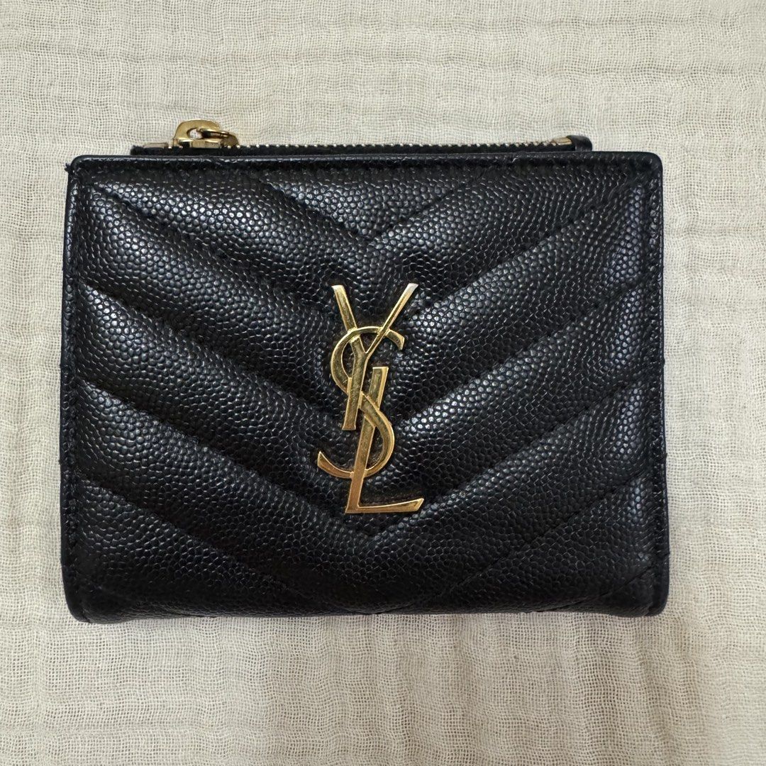 YSL Bi-Fold Wallet (Category: Luxury Bags & Wallets) located in Quezon City. Submitted by wanderingpenguin (Listing ID 1462865823, Image 2). Description: YSL wallet Well taken care of Guaranteed authentic Complete with receipt, dust bag, and box No chipping in the leather & lining Issue: Gold fading in some areas as seen on photos Measurements & other details seen on last photo Can send more photos upon request.