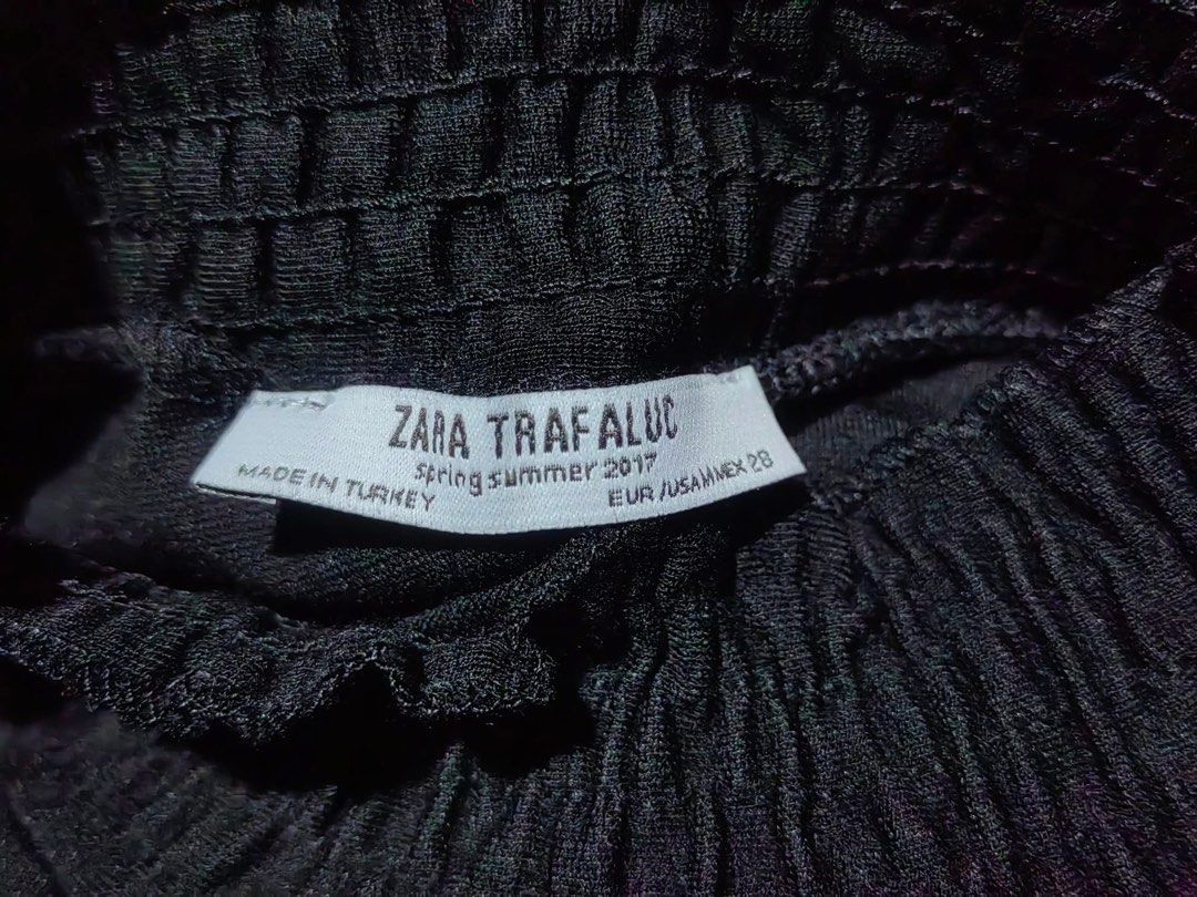 Zara Black Mock Neck Textured Top (Category: Blouses) located in Donsol. Submitted by saksthriftavenuebyluckymaria8 (Listing ID 1462880271, Image 3). Description: - Zara black short-sleeved top - Size: EUR 38 / US M - Features a mock neck with gathered, textured detail - Subtle textured pattern all over the fabric - Made in Turkey Zara black short-sleeved top with a gathered, smocked high neckline sz M chest 20in armhole 8in shoulder 16in length 