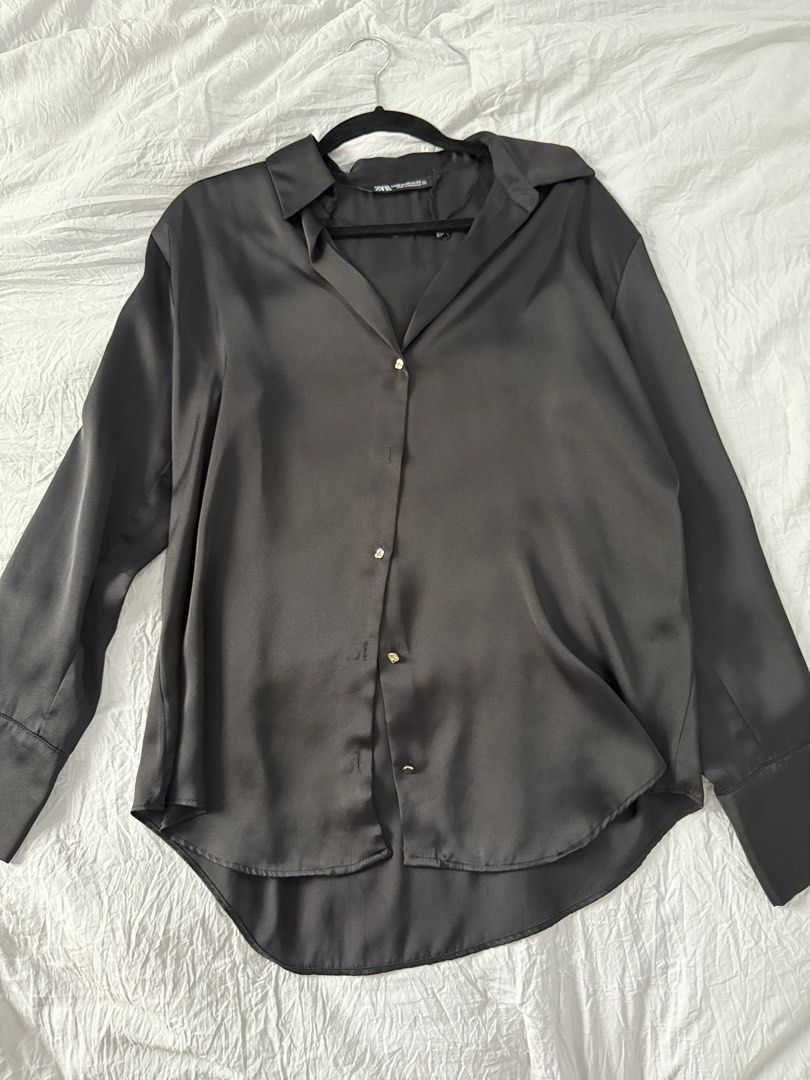 Zara Black Satin Button-Up Shirt (Category: Shirts) located in Bacoor. Submitted by annmaliksi (Listing ID 1462757938, Image 1). Description: - Zara black satin button-up shirt - Long sleeves with button cuffs - Curved hemline - Perfect for dressing up or down.