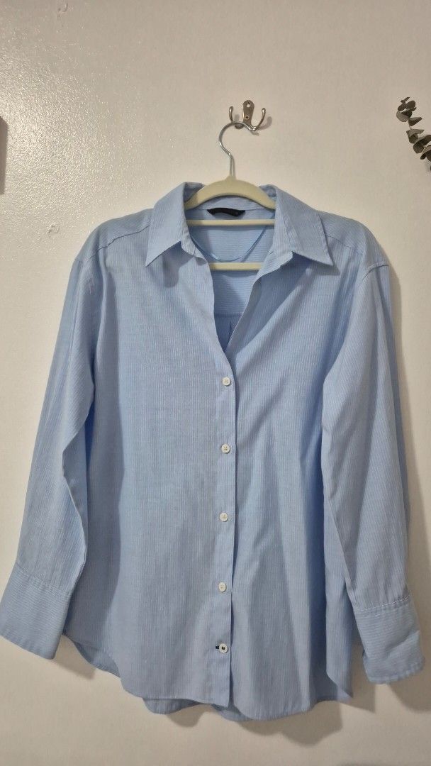 Zara Light Blue Pinstripe Button-Up Shirt (Category: Tshirts & Polo Shirts ) located in Pasig City. Submitted by magnoliafern (Listing ID 1462816498, Image 1). Description: - Zara light blue button-up shirt - Subtle pinstripe pattern - Made in Morocco - Material: 56% Cotton, 44% Polyester - Versatile for casual or work attire.