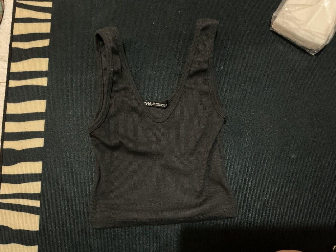 Zara Ribbed Tank Top (Category: Sleeveless) located in Quezon City. Submitted by nicskulasa (Listing ID 1462811478, Image 1). Description: - Black ribbed tank top from Zara - V-neckline - Stretchy material - Versatile basic piece for your wardrobe - Easy to pair with any bottoms.
