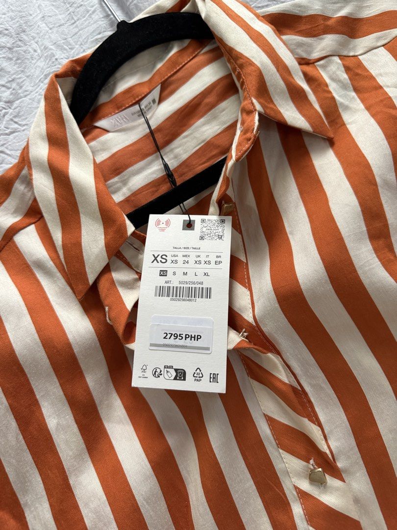 Zara Striped Button-Up Shirt XS (Category: Shirts) located in Bacoor. Submitted by annmaliksi (Listing ID 1462756771, Image 2). Description: - Zara orange and cream striped button-up shirt - Long sleeves with cuff detail - Size XS - Original tags attached - Versatile for casual or dressy wear RFS: Decluttering.