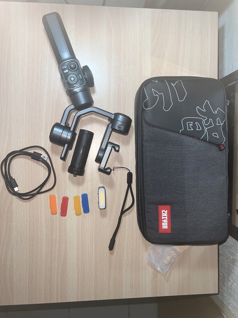 Zhiyun Smooth 5S - good/clean condition with complete accessories + case (Category: Gimbals & Stabilizers ) located in Taguig. Submitted by preloved.kitten (Listing ID 1462731339, Image 1). Description: This is a Zhiyun SMOOTH 5 smartphone gimbal/stabilizer. I bought in Japan back in 2025. I used it minimally. RFS: short hobby and need funds. Please research about the product how to use it. ABOUT THE PRODUCT: The main unit has no noticeable scrat