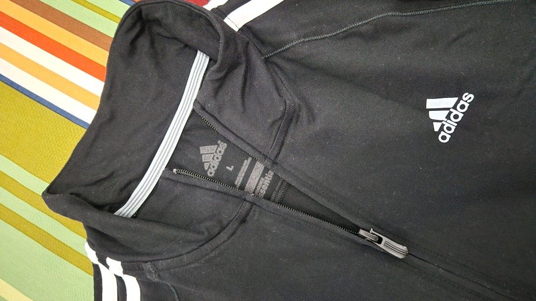 Adidas Track Jacket Black White Stripes Size L (Category: Coats, Jackets and Outerwear) located in Manila. Submitted by happybear_77e59e777 (Listing ID 1459204696, Image 1). Description: - Black Adidas track jacket - Classic white stripes on sleeves - Full zip closure - Front pockets - Size L - Ideal for sports or casual wear.