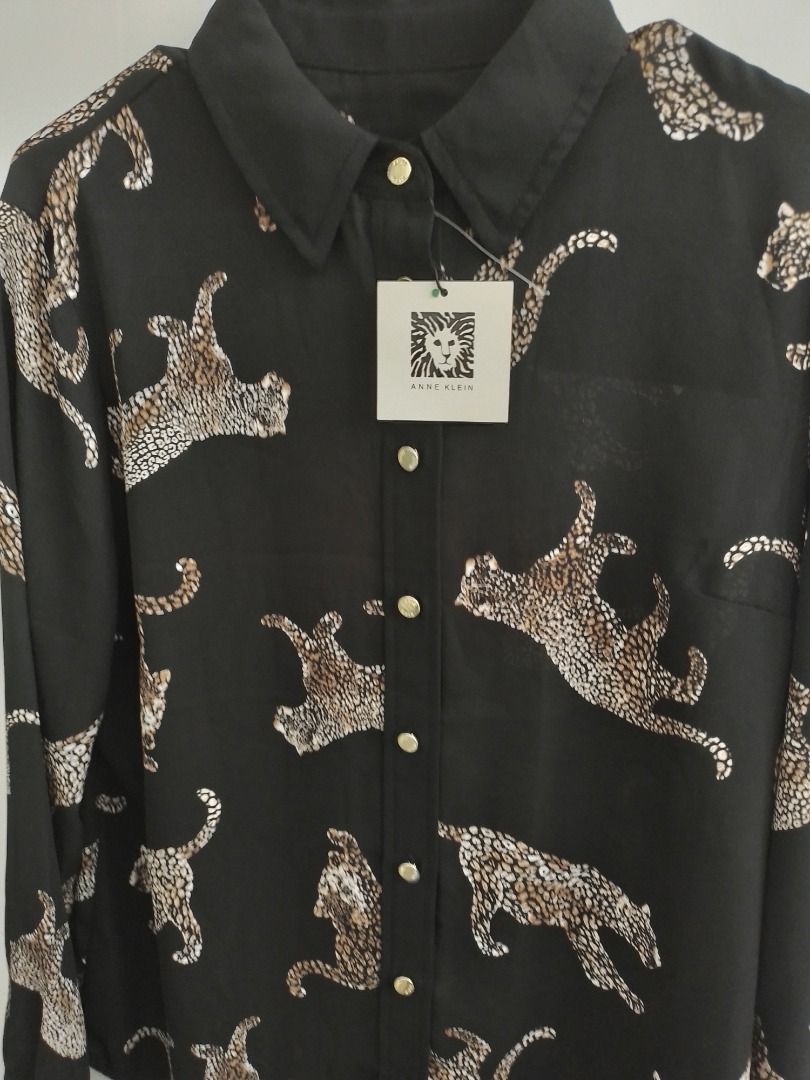 Anne Klein Black Leopard Print Button-Up Shirt (Category: Shirts) located in General Trias. Submitted by belinajg (Listing ID 1459132949, Image 1). Description: - Brand: Anne Klein - Color: Black with all-over leopard print - Style: Button-up shirt - Features: Long sleeves, gold buttons - Size: XS - Versatility: Perfect for dressing up or down.