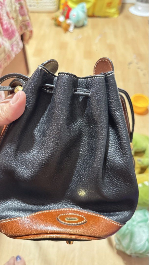 Bally Black and Tan Leather Drawstring Bucket Bag (Category: Luxury Bags & Wallets) located in Manila. Submitted by ririkah (Listing ID 1459092091, Image 3). Description: - Vintage Bally bucket bag - Black pebbled leather with tan leather trim - Drawstring closure - Adjustable shoulder strap - Gold-tone hardware - Minor scuffs on leather and base (consistent with age) - Classic and timeless design - BALLY IS A LUXURY BRAND - Google muna bago humi