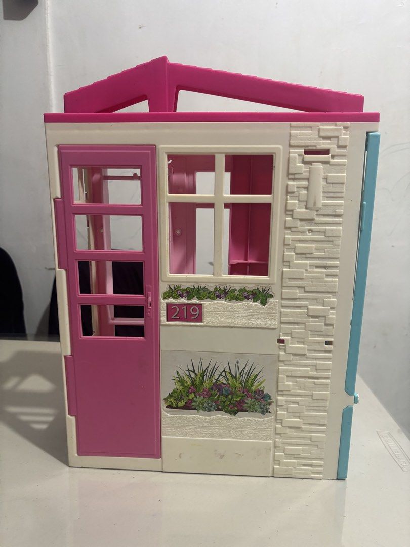 Barbie Getway Dollhouse (Category: Kids Toys) located in Quezon City. Submitted by lorenepb (Listing ID 1459102279, Image 2). Description: - Adorable pink and white foldable dollhouse - Comes with a bed and toilet - Features a front door that opens and closes - Perfect for sparking imaginative play - Folds up for convenient storage - Shows minor scuffs from normal use - Ready for its next adventure!.