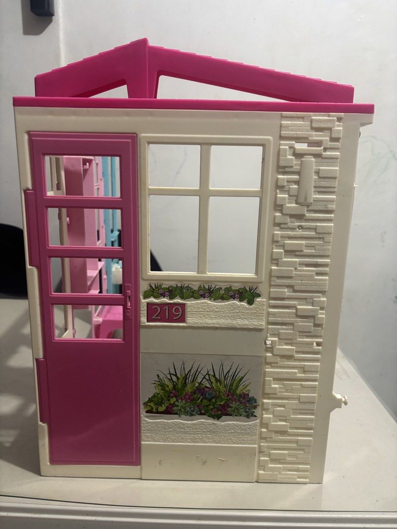Barbie Getway Dollhouse (Category: Kids Toys) located in Quezon City. Submitted by lorenepb (Listing ID 1459102279, Image 3). Description: - Adorable pink and white foldable dollhouse - Comes with a bed and toilet - Features a front door that opens and closes - Perfect for sparking imaginative play - Folds up for convenient storage - Shows minor scuffs from normal use - Ready for its next adventure!.