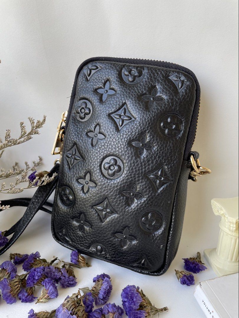 Black Embossed Monogram Phone Pouch Bag (Category: Purses & Pouches) located in Taguig. Submitted by ilovetradra (Listing ID 1459094669, Image 1). Description: - Black leather pouch bag with embossed monogram pattern. - Zipper closure for security. - Convenient front pocket with snap button. - Elegant gold hardware details. - Detachable strap for crossbody or shoulder styling. - Lined interior, ideal for phone and daily essentials..