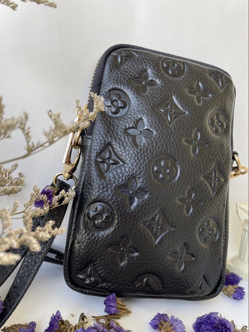 Black Embossed Monogram Phone Pouch Bag (Category: Purses & Pouches) located in Taguig. Submitted by ilovetradra (Listing ID 1459094669, Image 2). Description: - Black leather pouch bag with embossed monogram pattern. - Zipper closure for security. - Convenient front pocket with snap button. - Elegant gold hardware details. - Detachable strap for crossbody or shoulder styling. - Lined interior, ideal for phone and daily essentials..