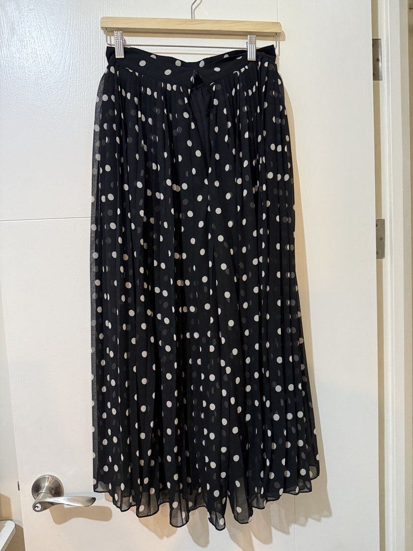 Black Polka Dot Pleated Midi Skirt (Category: Skirts) located in Manila. Submitted by shopdancedhanice (Listing ID 1459269278, Image 2). Description: - Black midi skirt with classic white polka dots - Elegant all-over pleating for a flattering silhouette - Made from lightweight fabric for comfortable wear - Perfect for dressing up or down, pairs beautifully with simple tops Note: Brand new from Mango but zipper is broken.