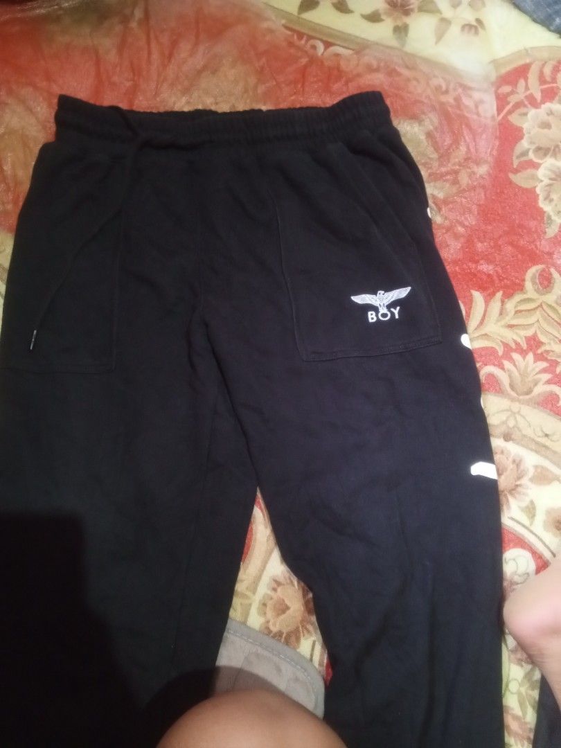 BOY London Black Sweatpants Size M (Category: Joggers) located in Caloocan City. Submitted by adrian011 (Listing ID 1459280380, Image 2). Description: - Brand: BOY London - Color: Black - Size: M (175/82B) - Features: Iconic eagle logo on right pocket, "LOVE THE BOY ALONE" graphic on back - Material: 100% Cotton - Style: Comfortable and stylish for everyday wear.