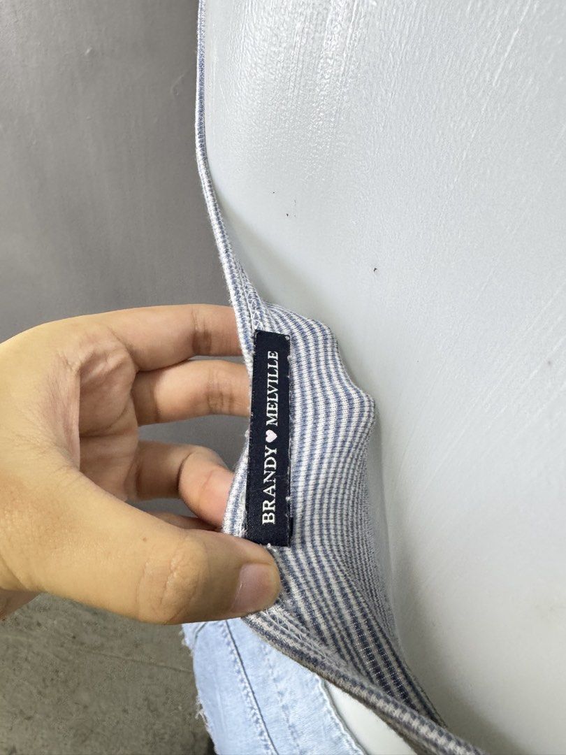Brandy Melville Striped Ribbed Crop Top (Category: Shirts) located in Lipa City. Submitted by gozosdanna (Listing ID 1459161410, Image 3). Description: - White ribbed crop top with thin blue stripes - V-neckline with button detail - Cropped length with a cute lettuce hem - Made in Italy - Ideal for everyday casual wear.