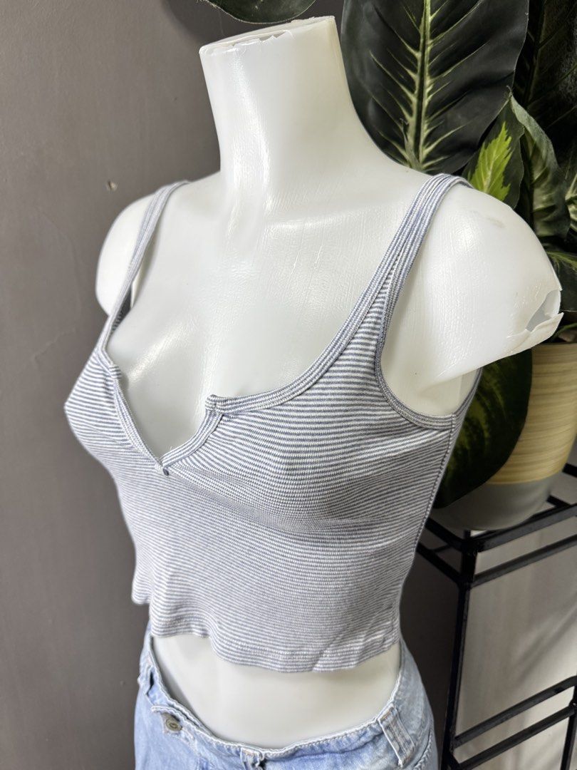 Brandy Melville Striped Ribbed Crop Top (Category: Shirts) located in Lipa City. Submitted by gozosdanna (Listing ID 1459161410, Image 2). Description: - White ribbed crop top with thin blue stripes - V-neckline with button detail - Cropped length with a cute lettuce hem - Made in Italy - Ideal for everyday casual wear.