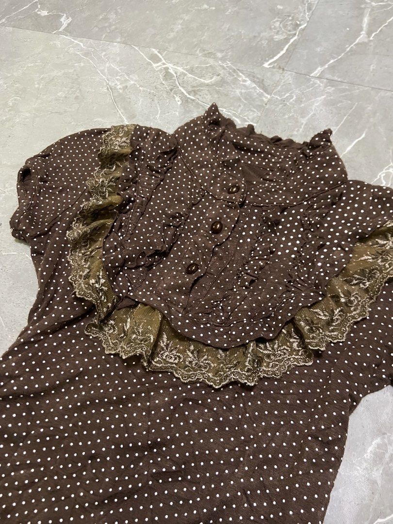 Brown Polka Dot Top with Lace Collar (Category: Dresses) located in Cebu City. Submitted by trueforest_k (Listing ID 1459237652, Image 2). Description: - Brown dress with white polka dots - Ruffled collar with delicate lace trim - Button-up front for adjustable fit - Short sleeves - Vintage-inspired, cute design - Versatile for casual outings or dressing up.