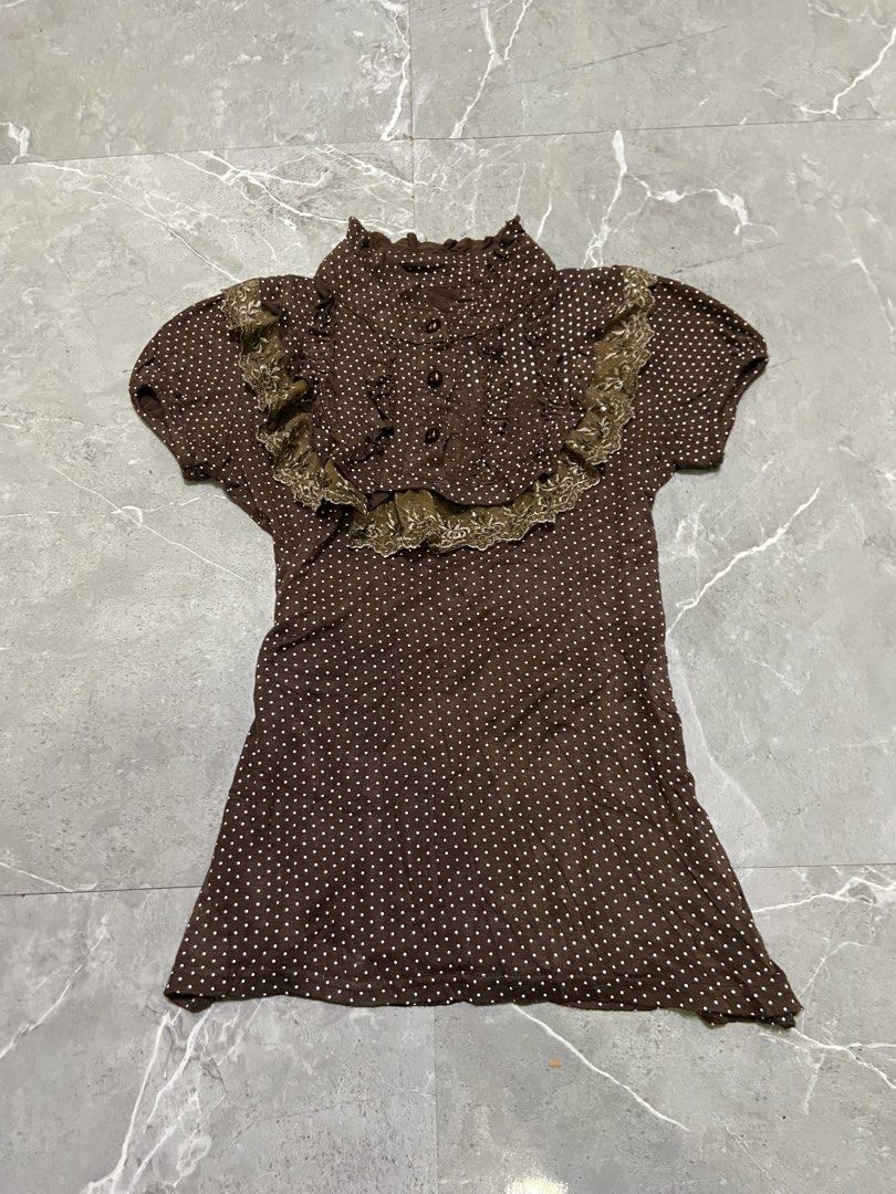 Brown Polka Dot Top with Lace Collar (Category: Dresses) located in Cebu City. Submitted by trueforest_k (Listing ID 1459237652, Image 1). Description: - Brown dress with white polka dots - Ruffled collar with delicate lace trim - Button-up front for adjustable fit - Short sleeves - Vintage-inspired, cute design - Versatile for casual outings or dressing up.