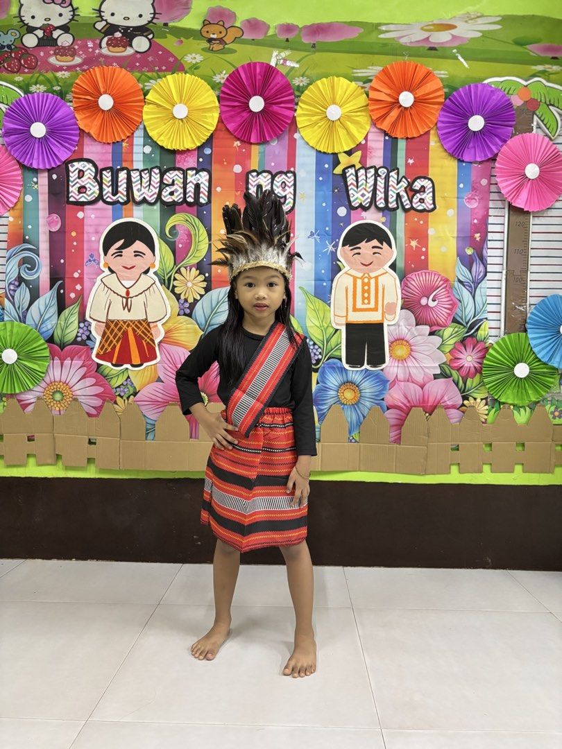 Buwang ng wika costume (Category: Babies & Kids Fashion) located in Malabon City. Submitted by kwisteyndg (Listing ID 1459091316, Image 1). Description: - Authentic traditional Filipino costume for children. - Set includes: black long-sleeved shirt, red & black striped skirt, sash with red/white accents. - Comes with a feathered headdress. - Perfect for cultural events, school presentations, or any special occasion. - Designed for young girls..