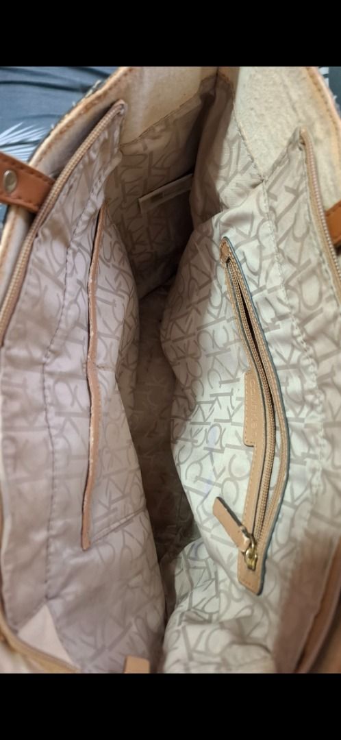 Calvin Klein Monogram Tote Bag (Category: Luxury Bags & Wallets) located in Cavite. Submitted by chinkee0215020 (Listing ID 1459163601, Image 2). Description: - Brown Calvin Klein tote bag - Signature monogram print - Tan leather straps and trim - Multiple interior compartments - Interior zippered pocket - Clean interior - Ideal for everyday essentials.