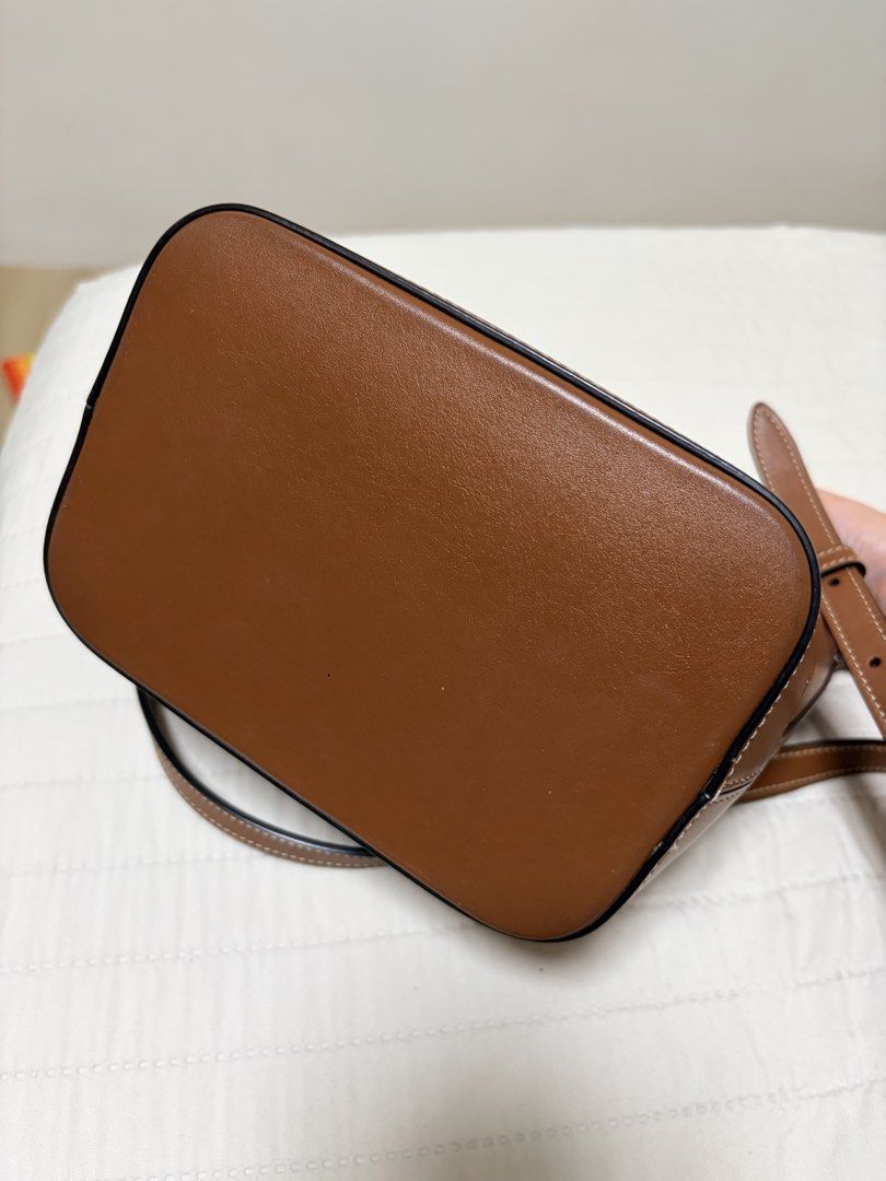 Celine Triomphe Canvas Bucket Bag Tan (Category: Luxury Bags & Wallets) located in Cainta. Submitted by jessicamaegalang (Listing ID 1459116775, Image 3). Description: - Authentic Celine Triomphe bucket bag - Embossed Triomphe logo on the front - Made of premium leather with white stitching details - Adjustable shoulder strap for comfortable carrying - Secure snap closure inside - Ideal for everyday use and versatile styling.