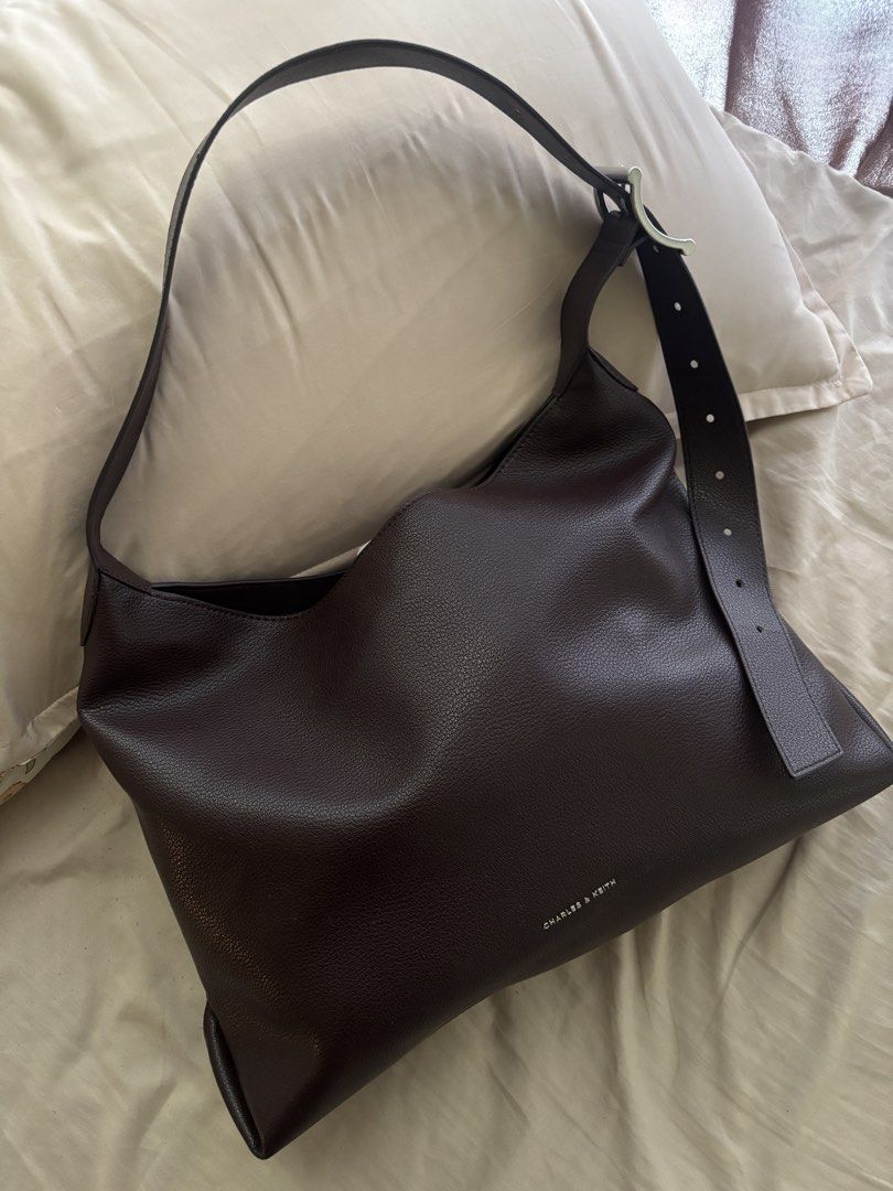 Charles & Keith hobo Shoulder Bag (Category: Shoulder Bags) located in Malabon City. Submitted by jesabibi (Listing ID 1459155092, Image 1). Description: - Brand: Charles & Keith - shade: plum - Material: Pebbled Leather - Features: Spacious interior, adjustable strap with buckle detail - bought in Japan last Oct. 2025 Negotiable.