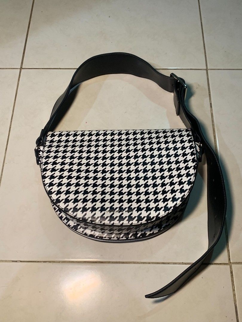 Charles & Keith Houndstooth Print Saddle Bag (Category: Cross-body Bags) located in Dipolog. Submitted by ethrifttt (Listing ID 1459257815, Image 1). Description: minimal issue (shown in pics), rust stain on magnet area excellent condition negotiable.