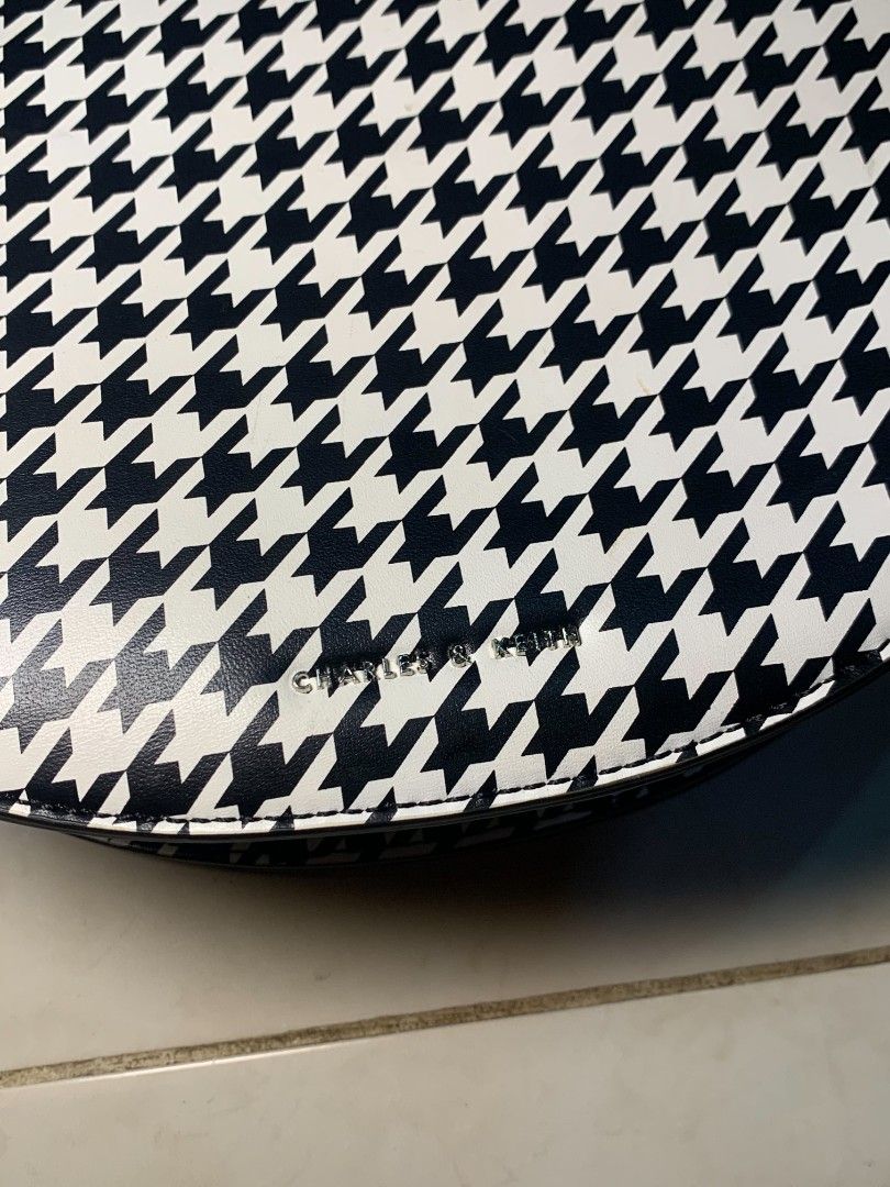 Charles & Keith Houndstooth Print Saddle Bag (Category: Cross-body Bags) located in Dipolog. Submitted by ethrifttt (Listing ID 1459257815, Image 2). Description: minimal issue (shown in pics), rust stain on magnet area excellent condition negotiable.