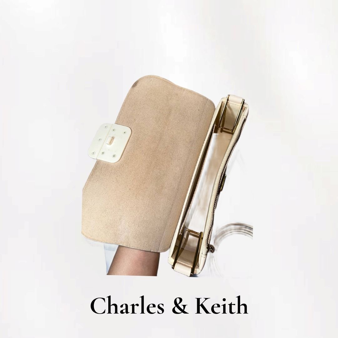 Charles & Keith White Shoulder Bag (Category: Shoulder Bags) located in Santa Rosa. Submitted by wynonamari62127 (Listing ID 1459158372, Image 3). Description: - Color: Nude color - Straps: Includes a short chain strap and a long adjustable strap - Interior: Suede-like lining - Comes with dust bag - Flaw is seen on the front flap but still looks usable.