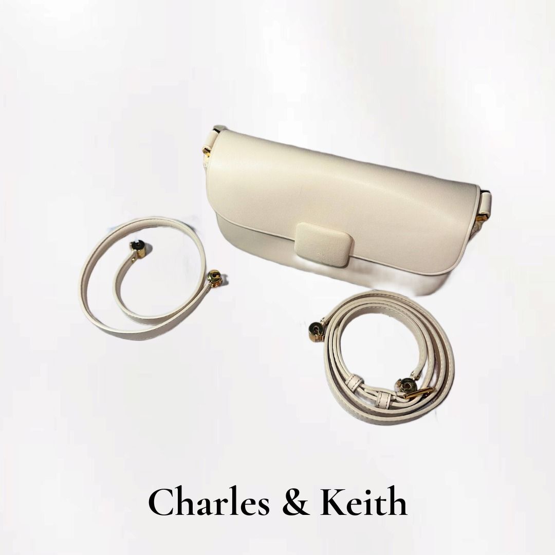 Charles & Keith White Shoulder Bag (Category: Shoulder Bags) located in Santa Rosa. Submitted by wynonamari62127 (Listing ID 1459158372, Image 2). Description: - Color: Nude color - Straps: Includes a short chain strap and a long adjustable strap - Interior: Suede-like lining - Comes with dust bag - Flaw is seen on the front flap but still looks usable.