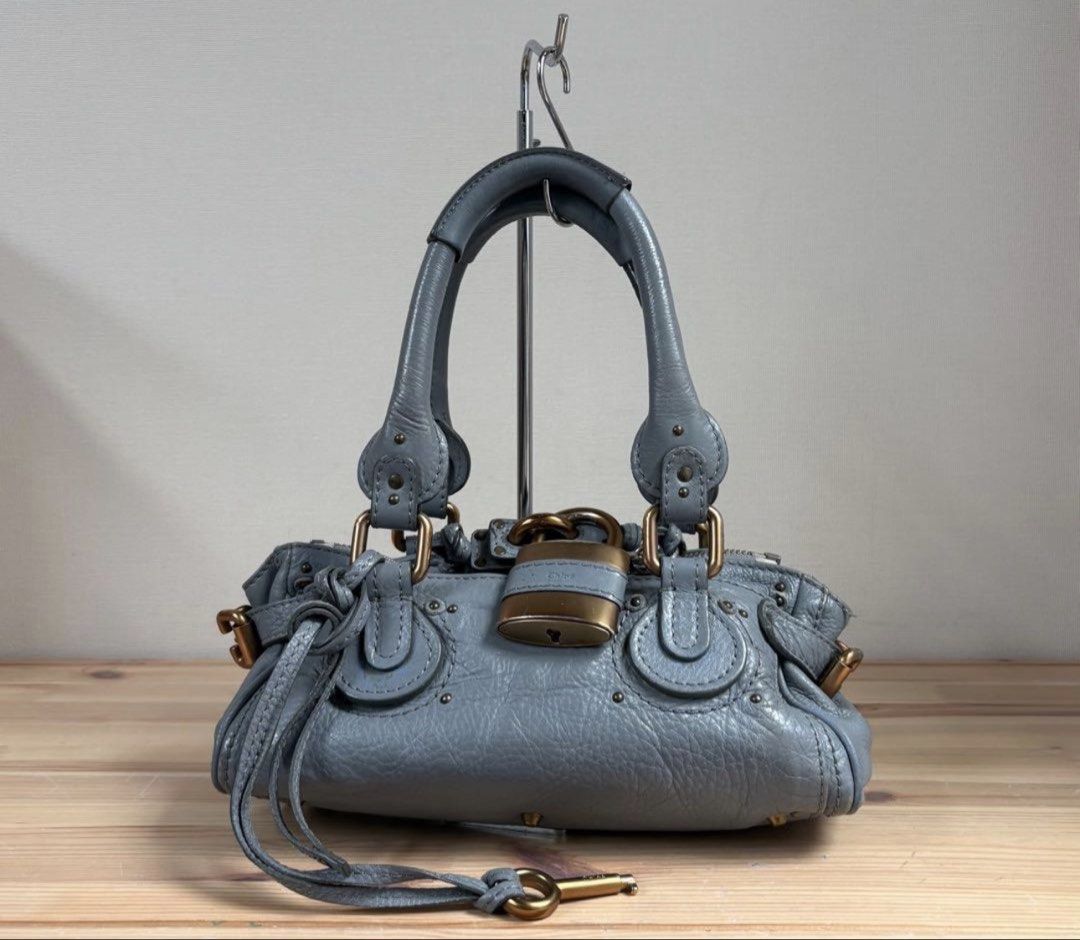 Chloe Paddington Mini Handbag Gray Leather (Category: Shoulder Bags) located in Las Pinas. Submitted by daisuki_japan_luxury_by_reiko (Listing ID 1459101028, Image 1). Description: ○ Product Description Good condition Chloe Padlock Small Paddington Handbag, shoulder carry ok Leather material ○ Color Gray ○ Accessories Padlock, key ○ Measurements (slight errors may occur) 27 x 14 x 14 cm Total height including handle: 31 cm ○ Condition Slight scuf
