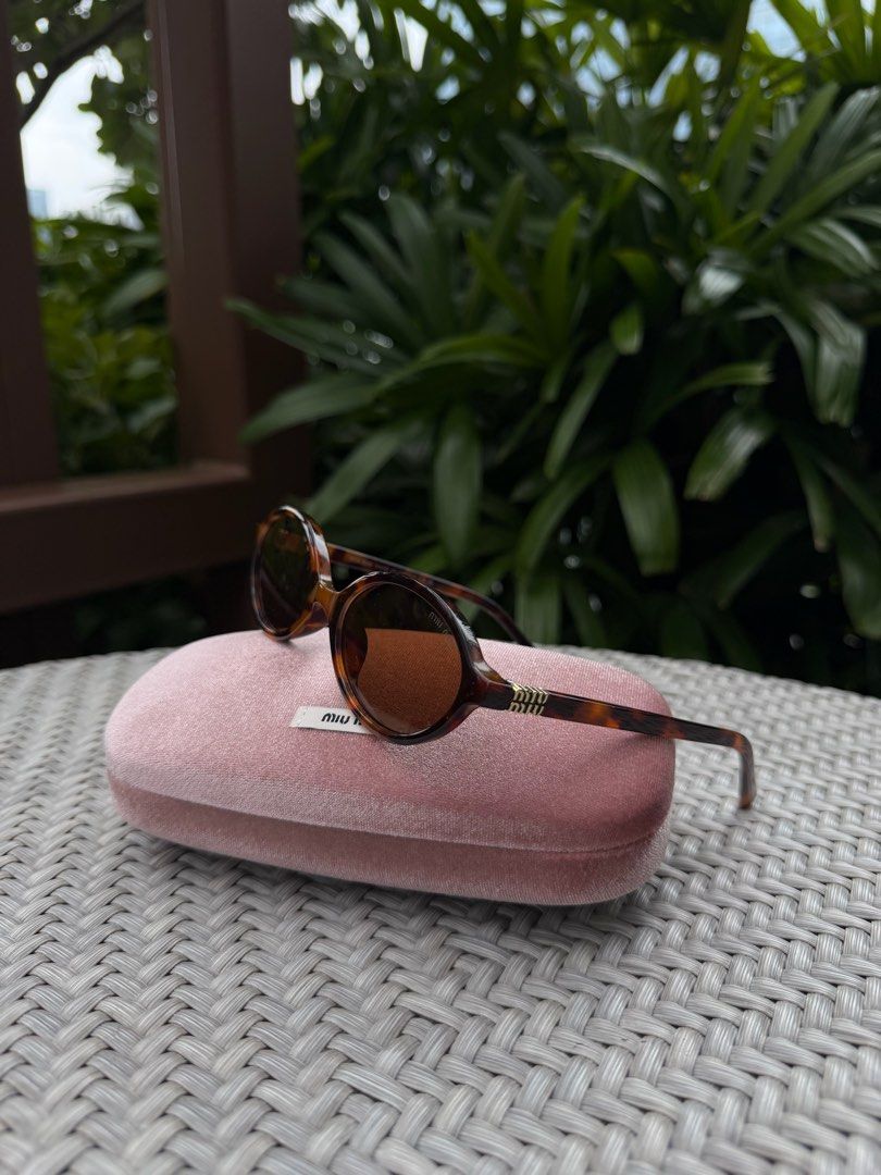 Classic Miu Miu Tortoise Shell Sunglasses with Case (Category: Sunglasses & Eyewear) located in Manila. Submitted by urbanglasses.mnl (Listing ID 1459244715, Image 2). Description: - Sourced from: 🇻🇳 - Model: SMU 04Z - Chic Tortoiseshell Pattern Frames - Includes the Miu Miu Pink Velvet Case - A versatile accessory to elevate any outfit.