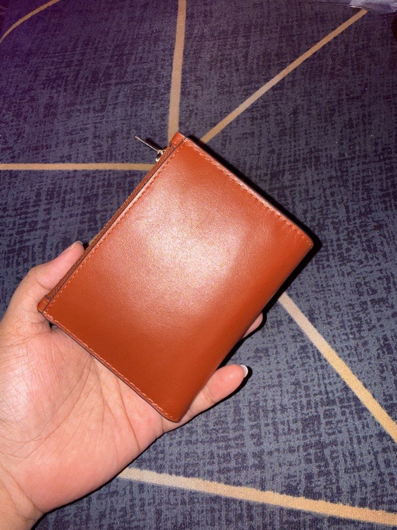 Coach Bifold Wallet - Rust Leather (Category: Luxury Bags & Wallets) located in Taytay. Submitted by bellakutch (Listing ID 1459270827, Image 2). Description: - Coach bifold wallet - Vibrant rust leather - Gold hardware - Zip-around coin pocket - Interior card slots and bill compartment - Clean inside and out - Ideal for everyday use - Inclusion: Tag and Care Card.