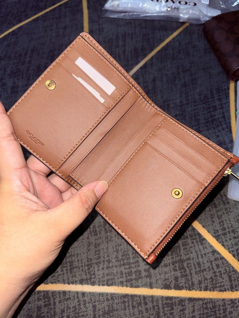 Coach Bifold Wallet - Rust Leather (Category: Luxury Bags & Wallets) located in Taytay. Submitted by bellakutch (Listing ID 1459270827, Image 3). Description: - Coach bifold wallet - Vibrant rust leather - Gold hardware - Zip-around coin pocket - Interior card slots and bill compartment - Clean inside and out - Ideal for everyday use - Inclusion: Tag and Care Card.