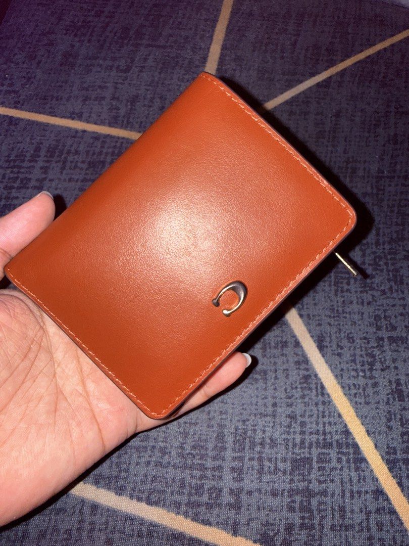 Coach Bifold Wallet - Rust Leather (Category: Luxury Bags & Wallets) located in Taytay. Submitted by bellakutch (Listing ID 1459270827, Image 1). Description: - Coach bifold wallet - Vibrant rust leather - Gold hardware - Zip-around coin pocket - Interior card slots and bill compartment - Clean inside and out - Ideal for everyday use - Inclusion: Tag and Care Card.