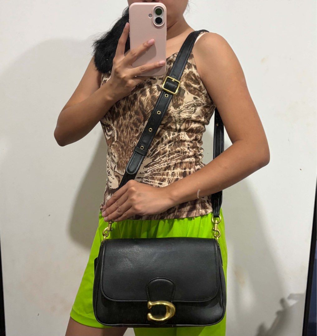 Coach Black Leather Shoulder Bag with Gold Hardware (Category: Luxury Bags & Wallets) located in Bacolod City. Submitted by jmcercado (Listing ID 1459153426, Image 1). Description: - Classic black leather shoulder bag - Features a gold buckle closure on the flap - Adjustable strap with gold hardware - Spacious interior, great for everyday essentials - Clean and well-maintained condition -missing shoulder strap -converted to cross/sling bag.