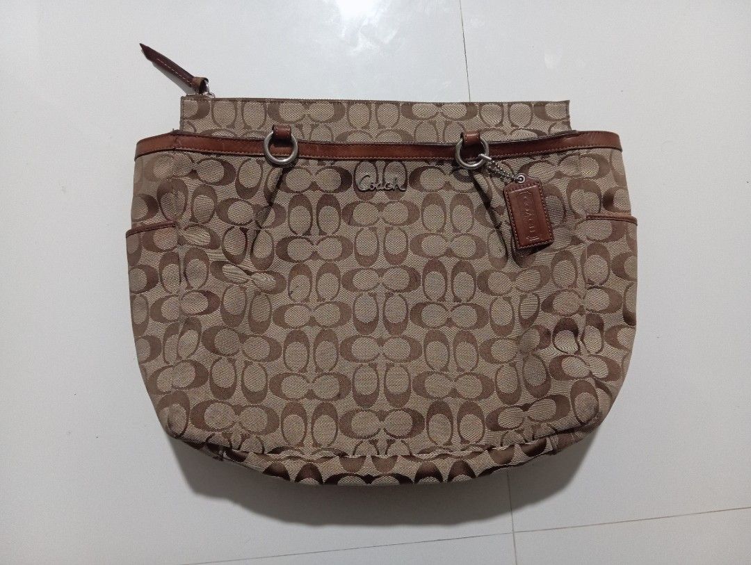Coach Monogram Canvas Leather Trim Tote Bag (Category: Luxury Bags & Wallets) located in Manila. Submitted by jzk25 (Listing ID 1459090715, Image 2). Description: - Classic Coach monogram tote bag - Color: Brown canvas with leather trim and handles - Features: Exterior slip pockets, interior zippered pocket - Iconic "C" monogram pattern - Perfect size for everyday use - Authenticity tag included missing lngnyung sling nya .
