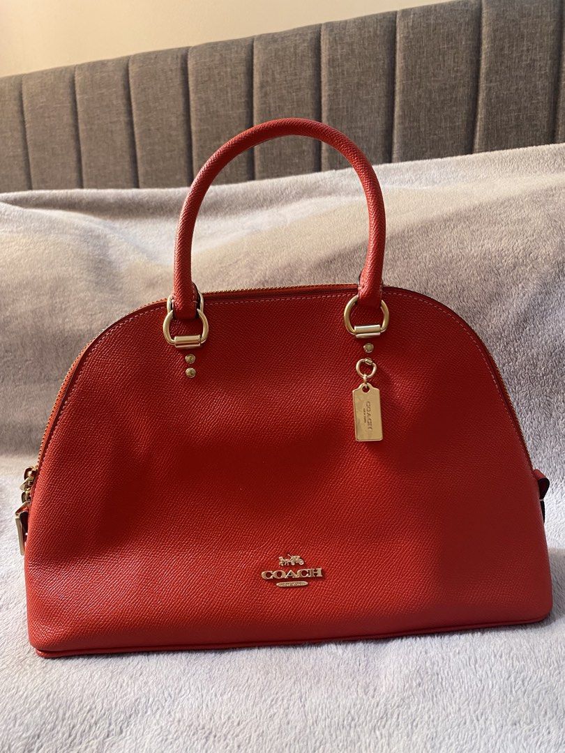 Coach Red Leather Dome Satchel Handbag (Category: Luxury Bags & Wallets) located in Manila. Submitted by six_seven67 (Listing ID 1459167045, Image 1). Description: Chic red leather Coach satchel with gold hardware. Perfect for everyday use, it offers ample space for your essentials..