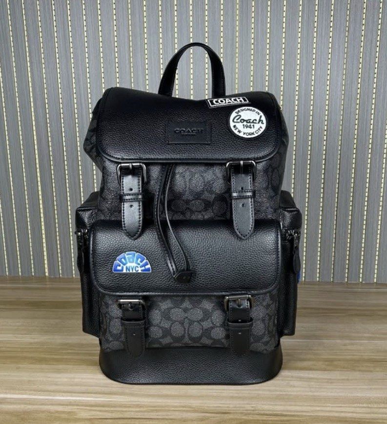 Coach Signature Backpack with NYC Patch (Category: Backpacks) located in Manila. Submitted by theoriginalboss (Listing ID 1459269075, Image 1). Description: - Authentic Black Coach backpack - Signature 'C' pattern - Flap top with buckle closures and drawstring - Front pocket with buckle closure - Side zip pocket - Includes 'Coach 1941 New York City' patch - Includes 'NYC' patch - Ideal for everyday use.
