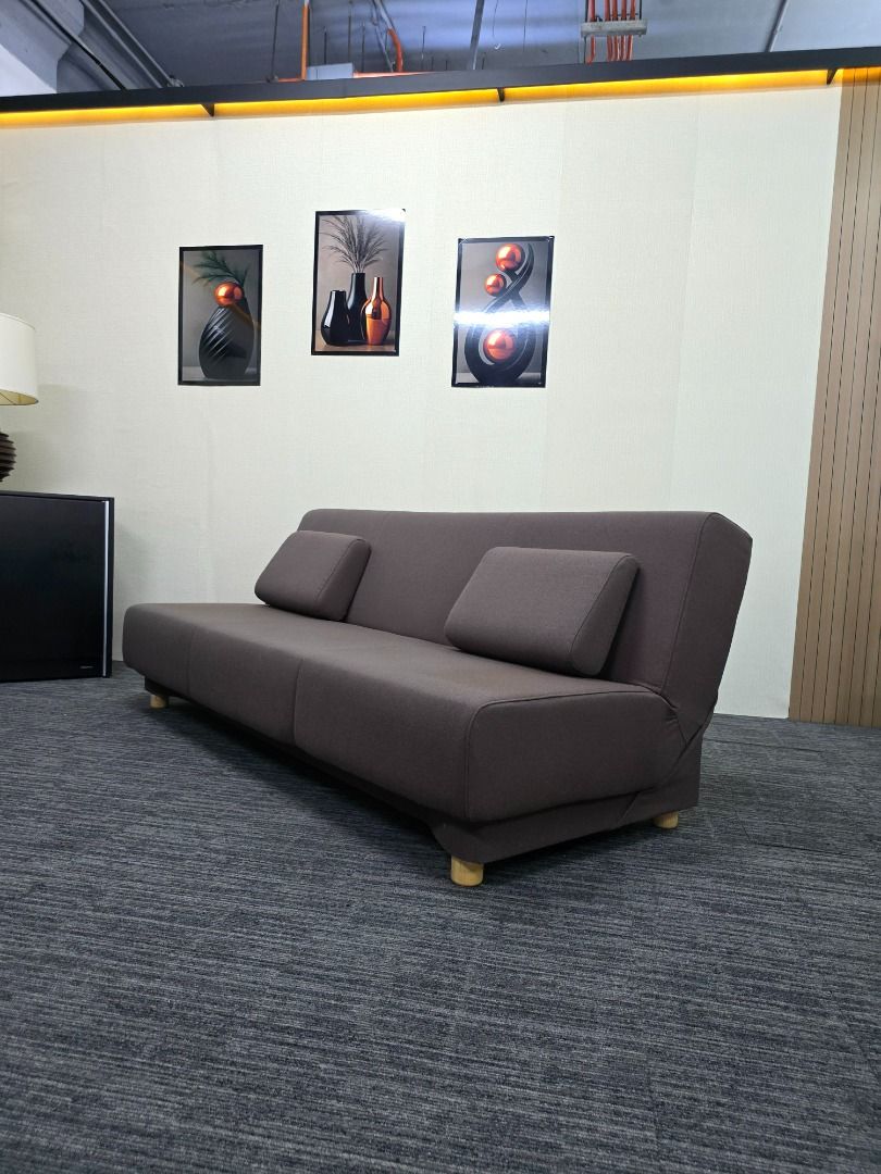 Convertible Sofa Bed with Pillows (Category: Sofas) located in Quezon City. Submitted by kevinmacabata12997160 (Listing ID 1459140487, Image 3). Description: - Versatile sofa bed in dark brown fabric - Easily converts from sofa to bed - Includes two matching pillows - Features simple wooden legs - Ideal for small spaces or guest rooms - Comfortably fits two people as a bed.