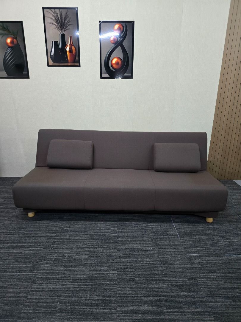 Convertible Sofa Bed with Pillows (Category: Sofas) located in Quezon City. Submitted by kevinmacabata12997160 (Listing ID 1459140487, Image 2). Description: - Versatile sofa bed in dark brown fabric - Easily converts from sofa to bed - Includes two matching pillows - Features simple wooden legs - Ideal for small spaces or guest rooms - Comfortably fits two people as a bed.