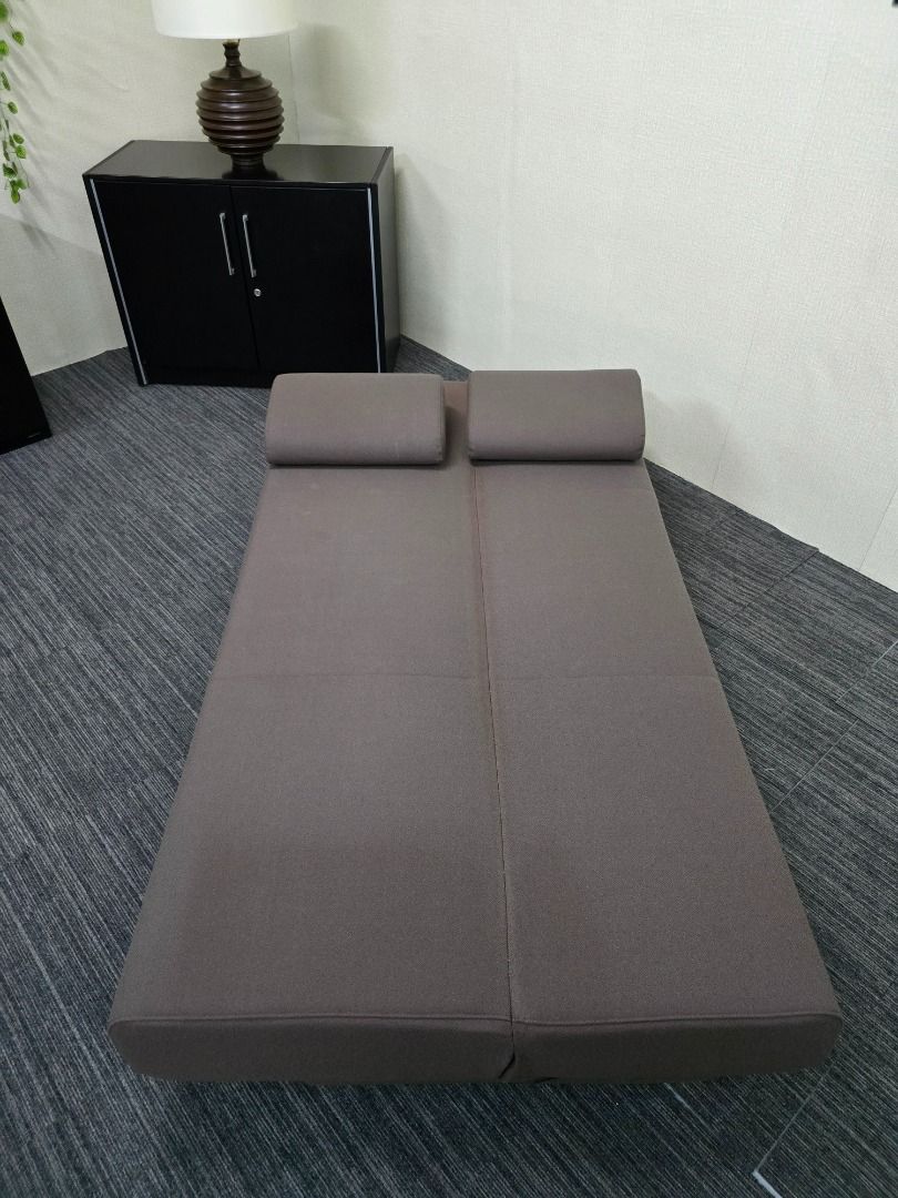 Convertible Sofa Bed with Pillows (Category: Sofas) located in Quezon City. Submitted by kevinmacabata12997160 (Listing ID 1459140487, Image 1). Description: - Versatile sofa bed in dark brown fabric - Easily converts from sofa to bed - Includes two matching pillows - Features simple wooden legs - Ideal for small spaces or guest rooms - Comfortably fits two people as a bed.