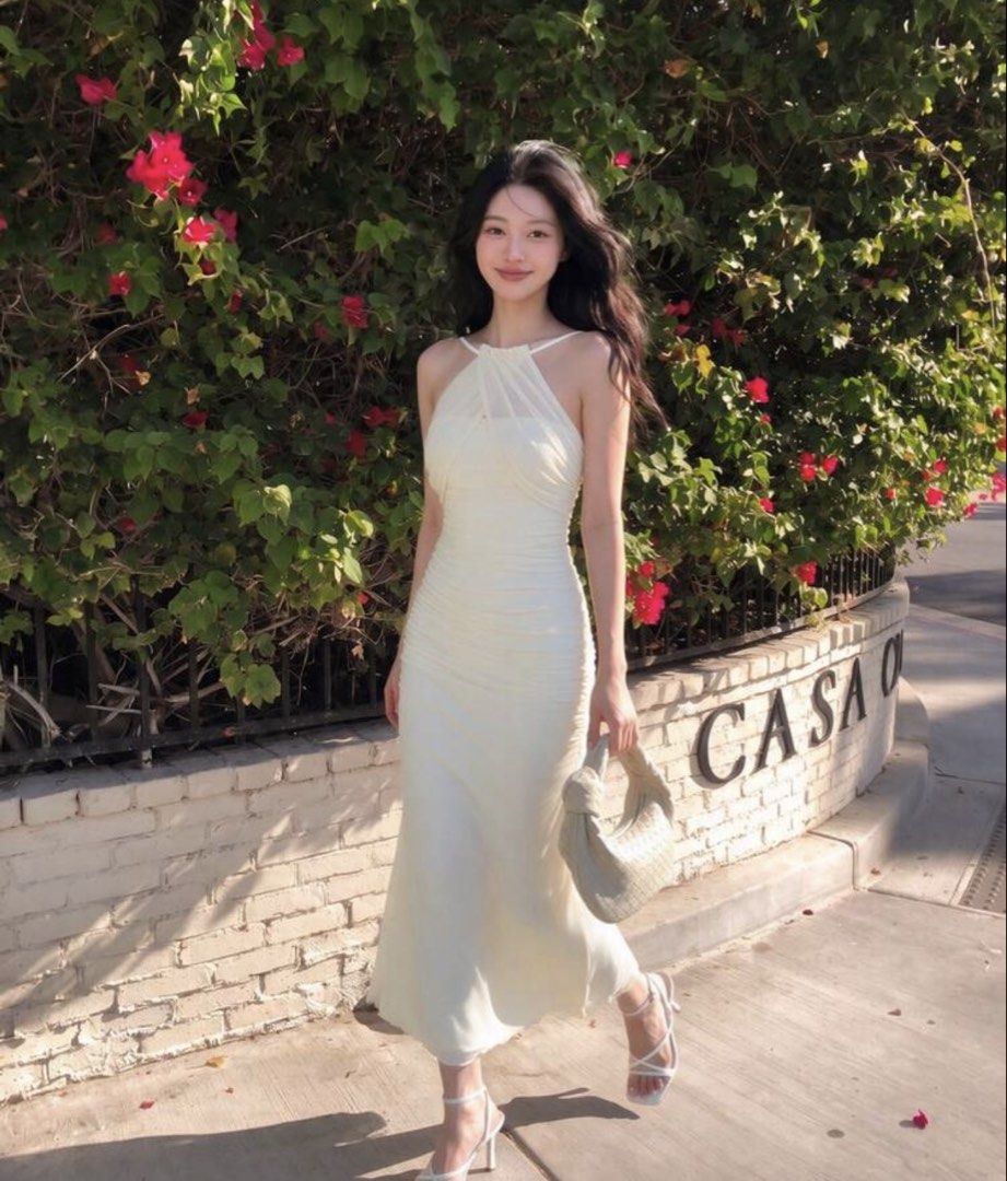 Cream Halter Neck Ruched Midi Dress (Category: Dresses) located in Quezon City. Submitted by cozykath (Listing ID 1459258404, Image 1). Description: - Cream halter neck midi dress - Features a ruched bodice - Flowy skirt - Spaghetti straps - Ideal for summer events or a night out - Comfortable and chic.